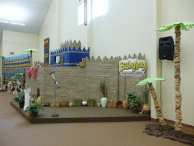 City set with buildings in Babylonian style, palm tree, and baskets
