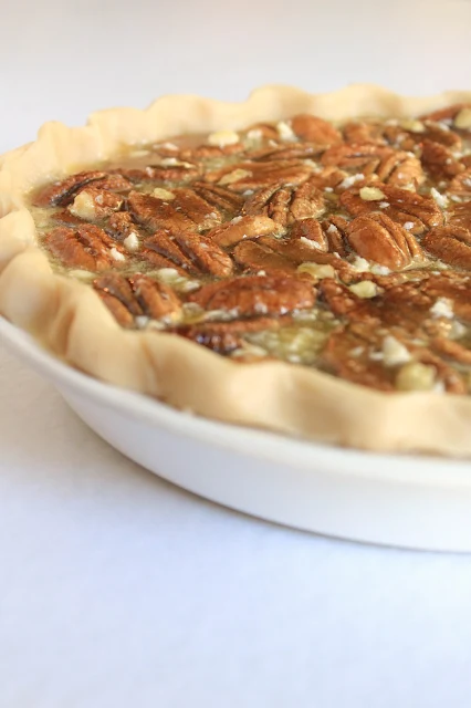 Maple Pecan Pie, a sweet, deep flavor of maple syrup complementing the richness of pecans in a classic pecan pie.  Perfect for any Thanksgiving meal!