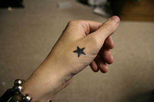 Single star hand tattoo.