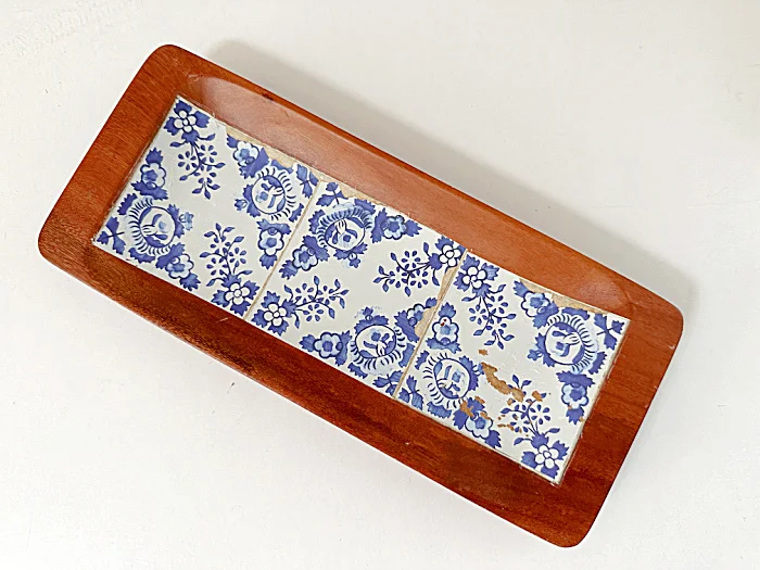 three tiles on rectangular wooden dish