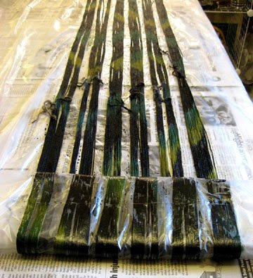 Silk warp being rolled up