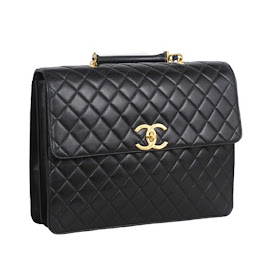 Vintage 1990's black leather quilted Chanel computer bag with gold "CC" logo.