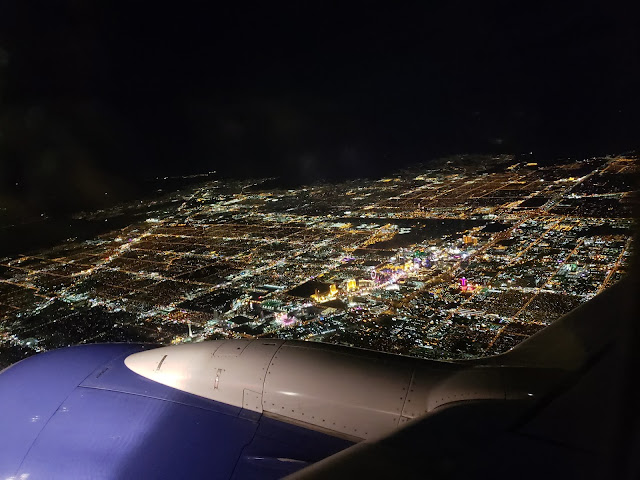 View of Las Vegas at night from over airplane wing