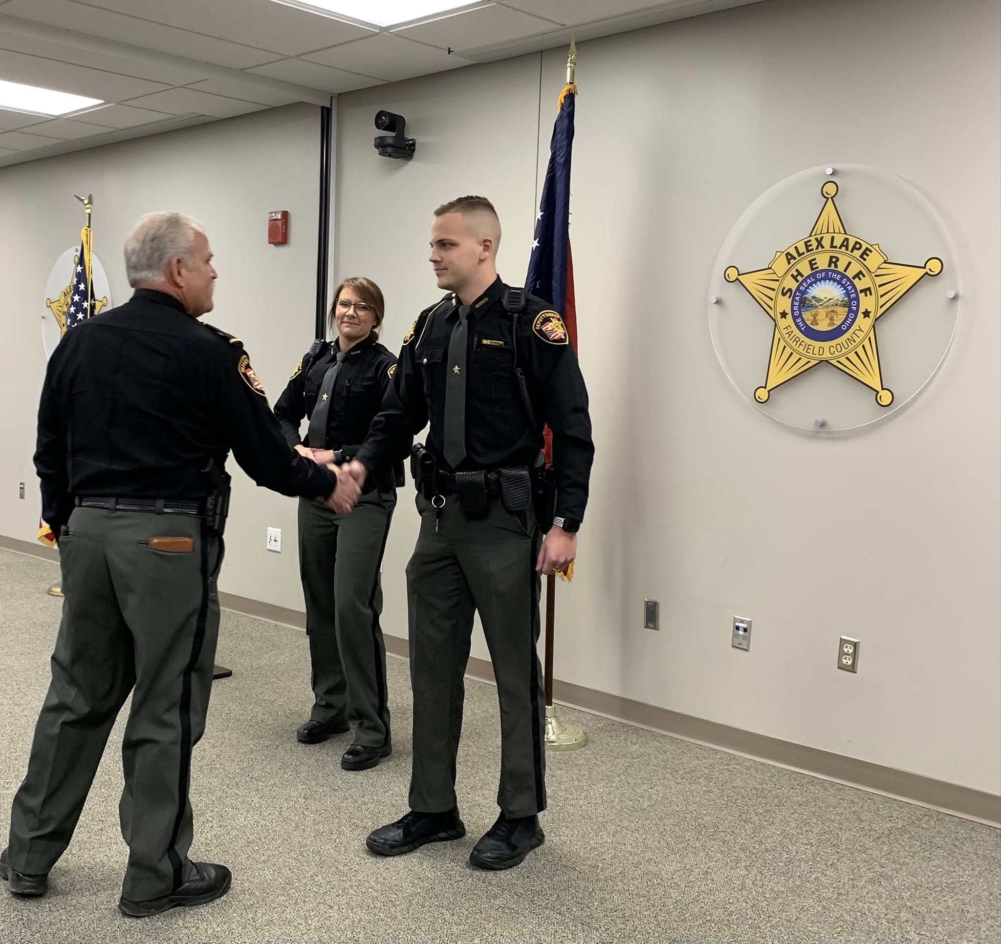 Lape shaking Deputy Luca Renner's hand