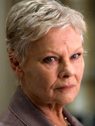 “M” is now a woman (heartless bitch that she is as played by Dame Judi .