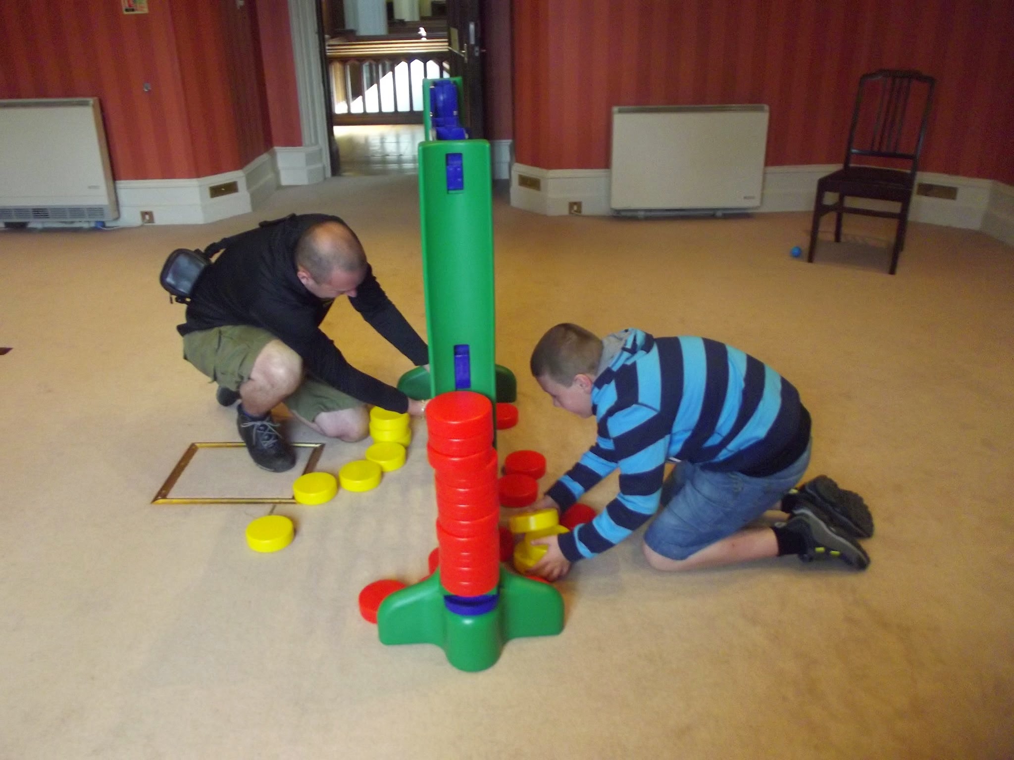 man and boy playing connect 4