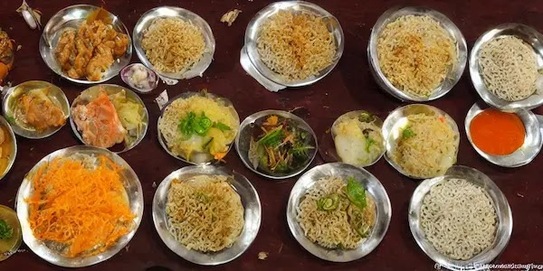 A traditional Arunachal Pradesh meal with rice, meat, and vegetables