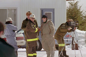 In this 1997 archival photo, investigators stand in front of a shed near a burned out house in St-Casimir, Que., where five people died. The five people are believed to be members of the Order of the Solar Temple.