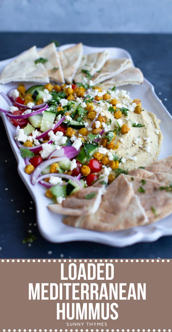 This Loaded Mediterranean Hummus is INSANELY TASTY! Imagine a warm slice of pita bread topped with creamy hummus and your favorite mediterranean toppings like tomatoes, red onion, feta, cilantro, crispy chickpeas, and cucumbers! SOOO GOOD, you need to make this ASAP!