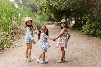 3 young girls holding hands getting ready to go hiking photo