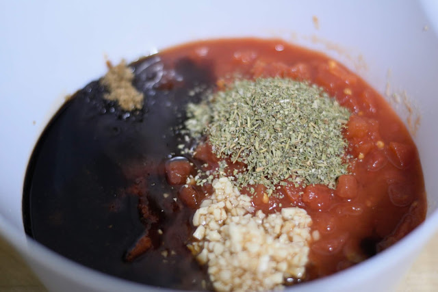 marinara sauce, balsamic vinegar, garlic, diced tomatoes, Italian seasoning, brown sugar, salt, and pepper in a mixing bowl.