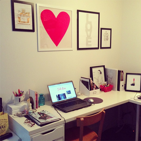 Vancouver-based beauty and style blogger Solo Lisa's home office space, featuring white furniture and framed prints.