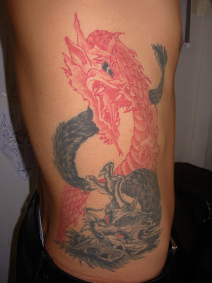 Red and black dragon body tattoo