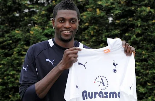 Emmanuel Adebayor holds up his new Tottenham Hotspur jersey