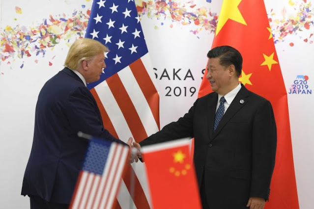 President Donald Trump shakes hands with President Xi Jinping during a meeting in Japan in 2019. Courtesy ​: Susan Walsh/Associative Press