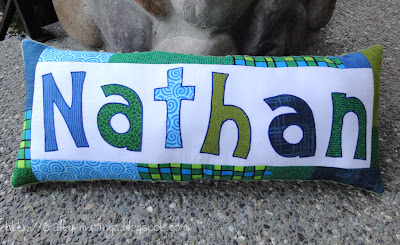 Nathan's happy blue/green pillow, front view