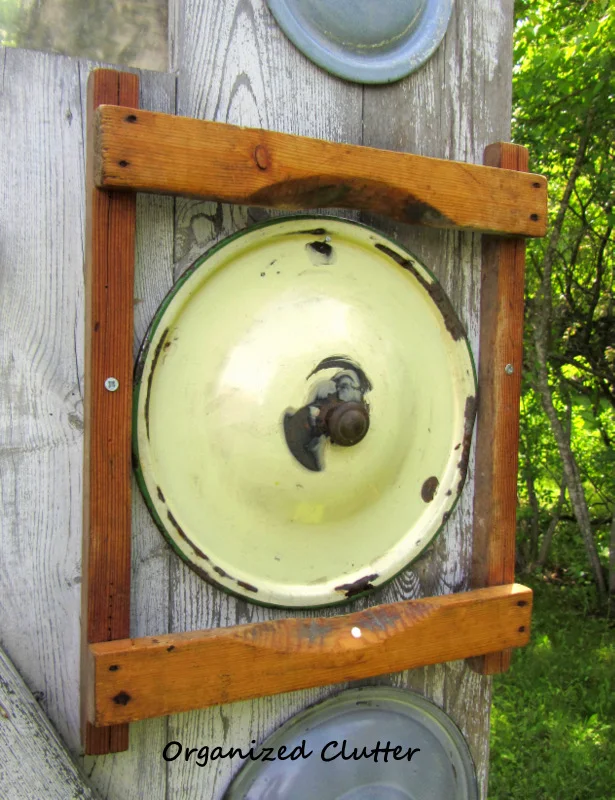 Garden Junk Decor: Lids on a Barn Door www.organizedclutterqueen.blogspot.com