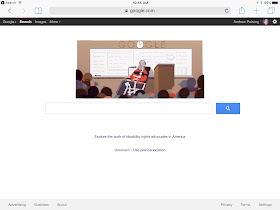Screen shot of the Google home page, featuring cartoon picture of Ed Roberts, a bearded man in an electric wheelchair and using a breathing machine.