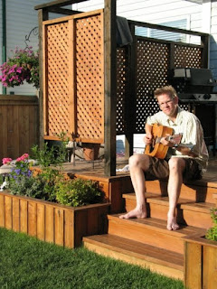 Playing my old guitar on our back porch on a summer evening