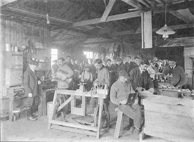 Black and white photo showing male internees at Knockaloe doing woodwork