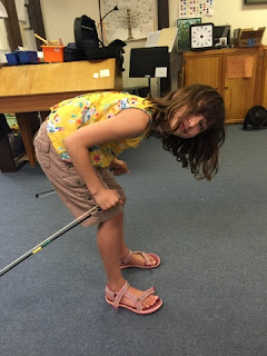 student uses violin bow as ski poles