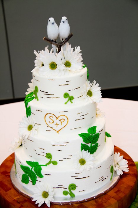 Pastel green and pink wedding cake with cute little birdhouse cake topper