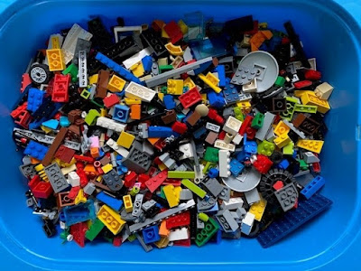Large blue plastic tub full of Lego bricks