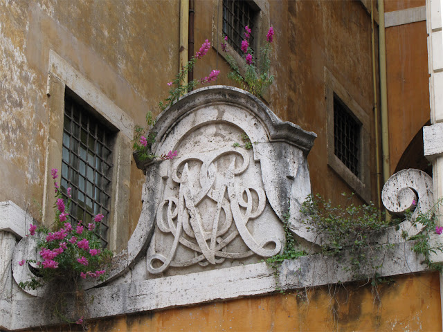 Monogram of the Monte di Pietà, Piazza della Trinità dei Pellegrini, Rome