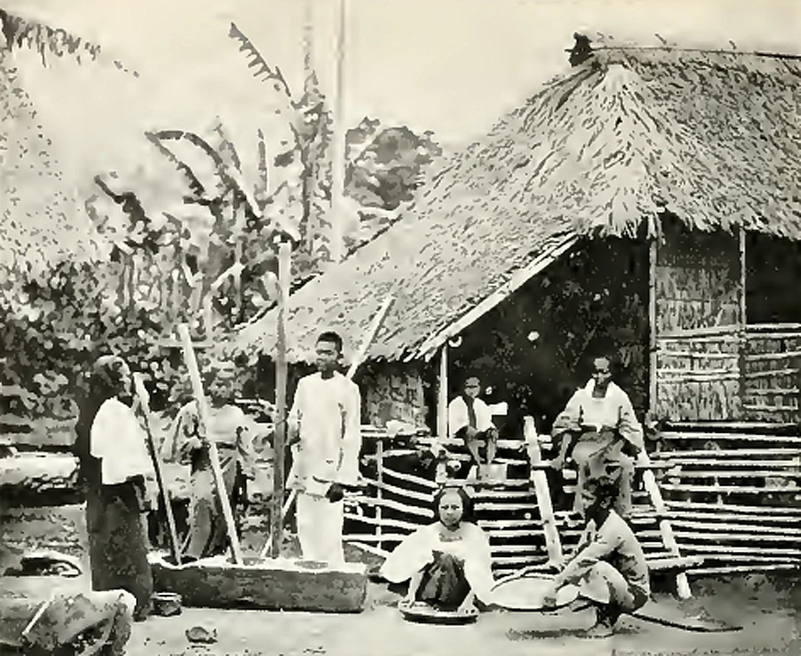 Family grinding corn in Luzon, American colonial era