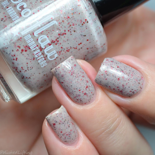 beige nail polish with red glitter