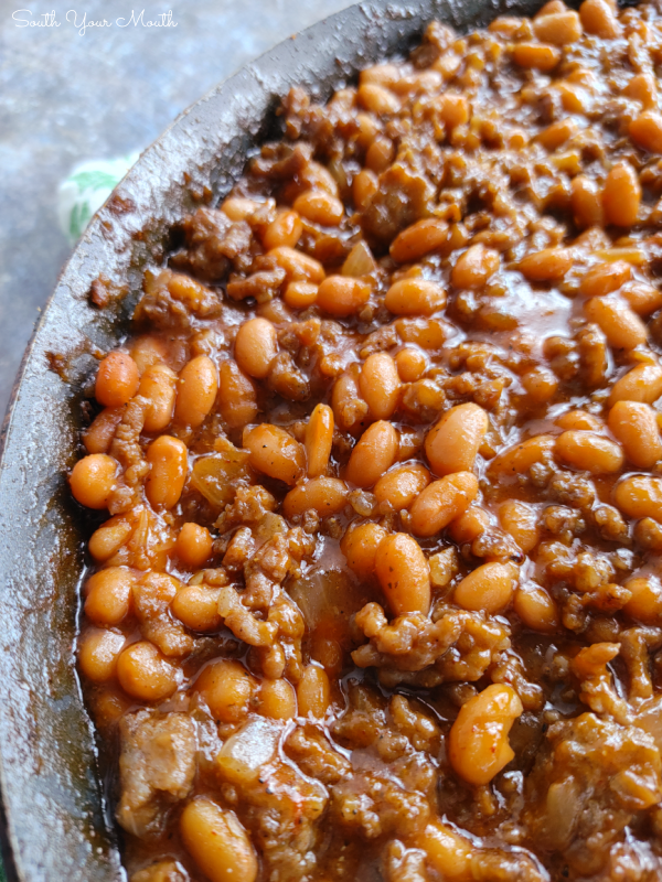 Cowboy Beans! A hearty recipe made with pork n' beans, ground beef, sausage, brown sugar and a simple sauce that's perfect for cookouts, barbeques and covered-dish affairs (finish in crock pot or on the stove).