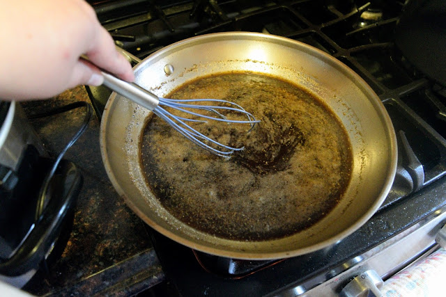 The sauce in the pan getting whisked.