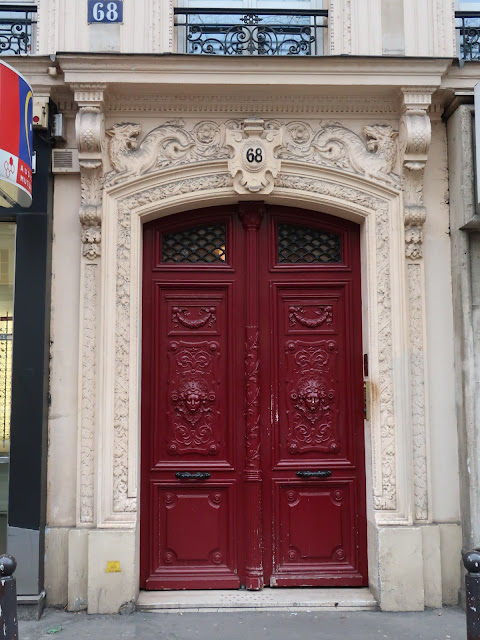 Stone building with a large red double doorway