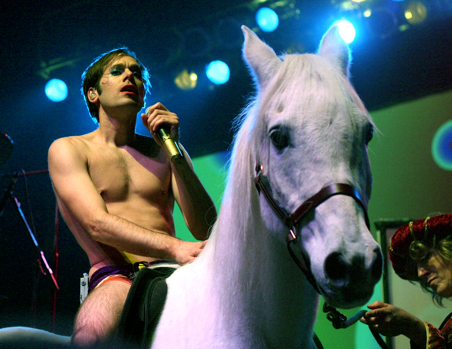 Highlights a tigermasked man in white tux jacket with tails 