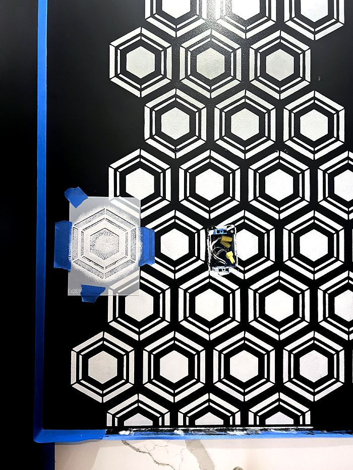 black and white hexagon stenciled design on wall