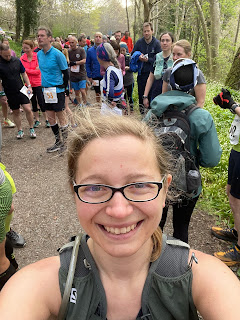 Selfie of me smiling with all the runners at the start behind me.