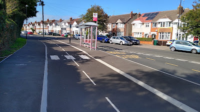 A pavement to the left, then the cycle track and a floating bus stop.