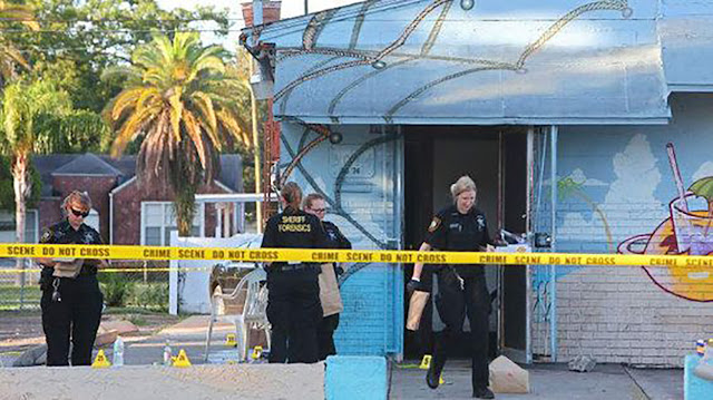 Members of the Pinellas Sheriff’s Department Forensics Team and St. Petersburg Police gather evidence at a murder scene in St. Petersburg, FL in 2017