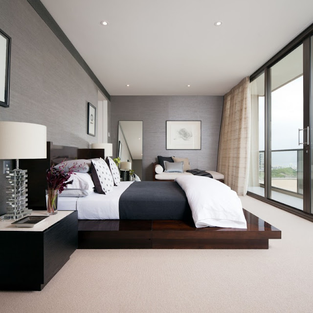 Photo of an amazing modern bedroom with king sized wooden bed