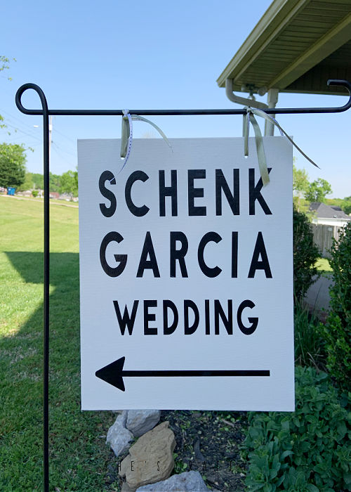 Wedding Venue Direction Signs hanging from metal flag holder.