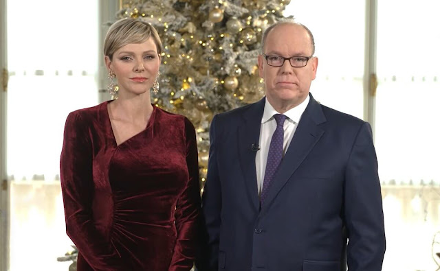 Princess Charlene wore a new burgundy Kinslee ruched velvet gown by Ralph Lauren Collection. The Princess is wearing gold earrings