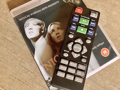 The DVD player remote sitting on the dvd of nightbirds