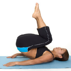 A woman doing a yogaasan for belly fat