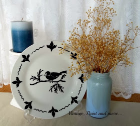 right facing display of completed plate with a candle and jar of flowers