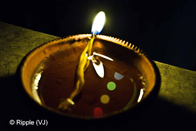 Posted by Ripple (VJ) : Diwali Celebrations 2008 (Indian Festivals of Lights): Diya with reflections of colorful lights on roof-boundary