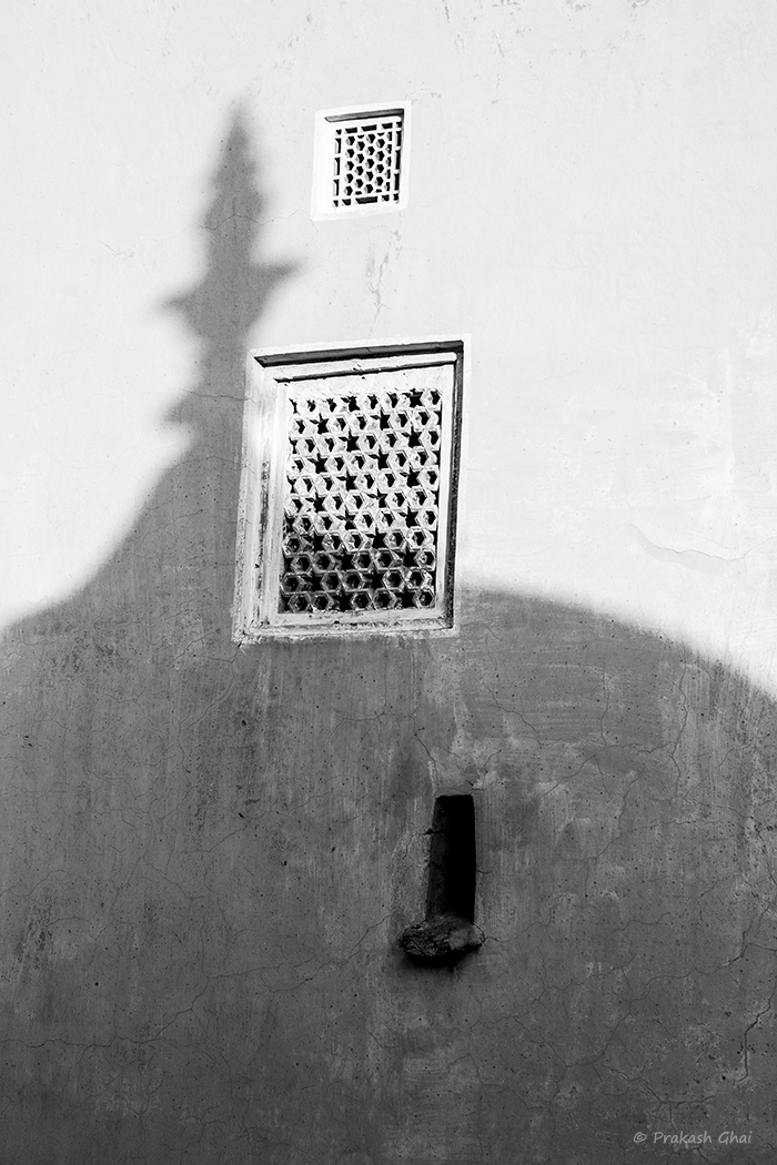 A Monochrome Minimalist Photograph of the abstract form/ shadow of the round dome versus geometrical shapes at Amer Fort, Jaipur