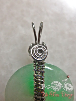 view of the little spiral behind the wire wrapped jade donut pendant