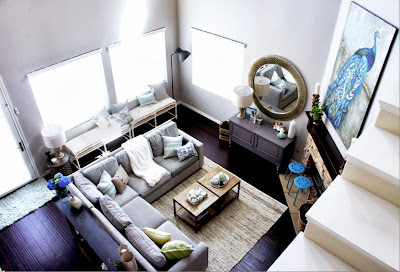 fresh and tranquil living room area with sectional sofa, fireplace view from upstairs