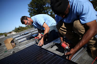 Installing solar on a rooftop, like this system on a home in San Mateo, Calif., is getting faster and easier as cities comply with a California law requiring a speedier permitting process. (Credit: Getty Images) Click to Enlarge.