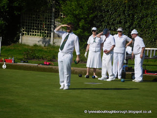 Young bowler shading eyes whilst looking towards the jack